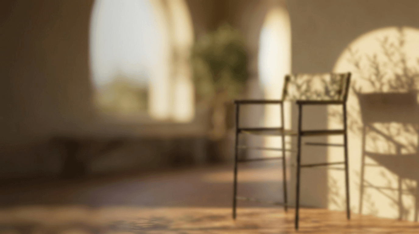 Metal bar stool in a room with arched windows, natural light and shadows